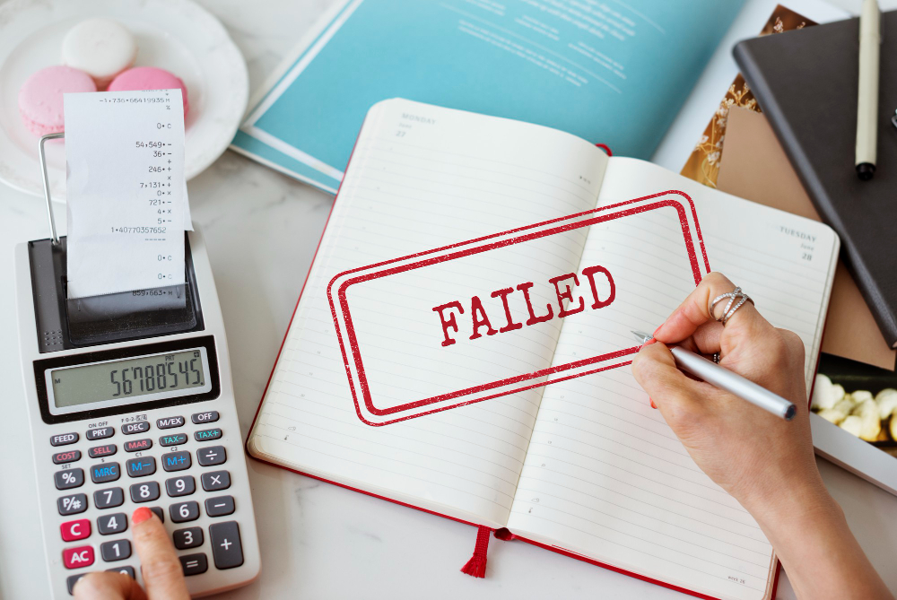 Failed OKR implementation shown with a planner, calculator, and red “FAILED” stamp